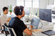 © BONNINSTUDIO/Stocksy - Focused software developer wearing headphones working on computer