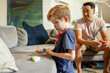 © Dylan Leeder/Stocksy - Boy Plays While Father Watches