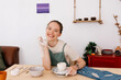 © Tania Cervian/Stocksy - Happy lady potter crafting ceramic dishware in workshop