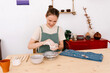 © Tania Cervian/Stocksy - Happy young female artisan making ceramics at home