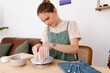 © Tania Cervian/Stocksy - Positive lady artisan making ceramic on pottery wheel