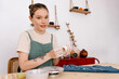 © Tania Cervian/Stocksy - Happy woman potter sculpting clay cup at home
