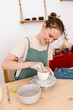 © Tania Cervian/Stocksy - Positive potter working with clay on pottery wheel
