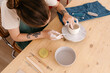 © Tania Cervian/Stocksy - Crop artisan designing clay bowl