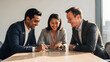 © FAHIM - Authentic candid photograph of a diverse business team having a positive meeting in a modern sunlit office.