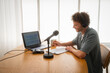 © Nuria Seguí/Stocksy - Podcaster During Podcast Broadcasting