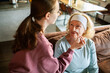 © Geber86 - Young woman applying face mask to smiling senior at home