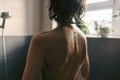 © Irina Efremova/Stocksy - Back View of Woman with Wet Hair in Sunlit Bathroom