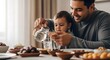 © Banstanks - Father pouring water for child at table mealtime home lifestyle