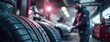 © Snowstudio - Mechanic working on vehicle with tires in automotive workshop