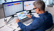 © Andrey Popov - Financial Analyst Man Using CRM System