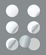 © Creative SHONJITA - Six blank white circular stickers with peeling corners on gray background