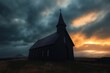 © Rgrd - Solitary dark wooden church with steeple and crosses beneath stormy clouds and a dramatic orange sunset over windswept grass, evoking solitude and quiet melancholy