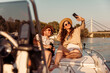 © Impact Photography - Couple having fun taking selfies while sailing on a boat on Danube river in Novi Sad city, Serbia