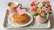 © Phanupong - Delicious Pancakes with Coffee and Fresh Flowers on Floral Tray Cozy Breakfast Celebration Sweet Start to Mothers Day