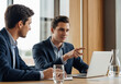 © Alexandr Peers - Meeting where analyst points at laptop screen during financial data review or general strategy discussion in office workspace environment for project success plan and collective growth result