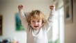 © Pro Hi-Res - Happy small child raising hands to celebrate an everyday achievement at home.