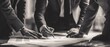 © Erwant - Business professionals collaborating around a table reviewing documents monochrome