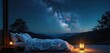 © Viktor - Bed under starry night sky with mountains. Lantern light illuminates a peaceful outdoor sleeping area. Milky Way galaxy visible above nature landscape.