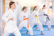 © JackF - Group of teenage girls in kimono doing kata training in gym