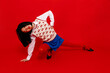 © Tania Cervian/Stocksy - Fashionable woman posing in red studio