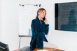 © Lucas Ottone/Stocksy - Professional businesswoman calling on the phone at work