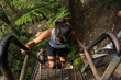 © Shava Cueva/Stocksy - Person Climbing Steps in a Lush Green Environment