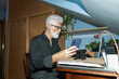 © Luis Velasco/Stocksy - Senior Man Using Smartphone And Laptop At Desk
