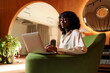 © Artem Podrez/Stocksy - professional woman typing on laptop in stylish business  space