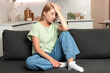 © brizmaker - Tired young woman feeling pain from headache at home