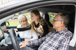 © Bethany Birnie/Stocksy - Grandparents and granddaughter in electric vehicle