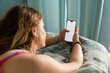 © Raymond Forbes LLC/Stocksy - Teenager girl cell phone video streaming  in bedroom