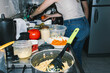 © Laura Herrera/Stocksy - Woman washing a tomato in the sink