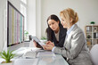 © Studio Romantic - Young business people company employees having discussion about financial data analyzing company accounting on meeting. Woman accountant working on pc with charts and talking with colleague.