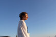 © Olga Murzaeva/Stocksy - A woman walks on the roof