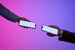 © Marc Tran/Stocksy - Two business people holding modern smartphones with blank screens
