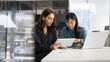 © fizkes - Serious diverse female managers analyzing online content on tablet together, pointing at screen, discussing Internet marketing strategy for product promotion, cooperating on project. Banner shot