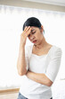 © Ton Photographer4289 - Young woman touching her temples with her hand because of severe headache due to stress or migraine. Health and mental health problem concept.