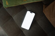 © DZ FILM/Stocksy - A mobile phone with white screen on the sofa
