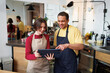 © Artem Podrez/Stocksy - Coffee Shop Team Reviewing Tablet Together