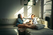 © Pedro Merino/Stocksy - Couple hanging out at home with their dogs