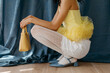 © Tania Cervian/Stocksy - Anonymous model crouching in stylish clothes and with a yellow bag