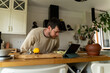 © Alba Vitta Studio/Stocksy - Man reading recipe tablet