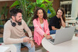 © Luis Velasco/Stocksy - Laughing Coworkers Collaborating On Laptop