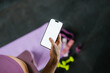 © DZ FILM/Stocksy - A woman uses white-screen mobile phone in the gym