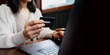 © Ton Photographer4289 - Woman holding a credit card while using a laptop for online shopping at cafe. Conceptual image representing e-commerce, digital payment.