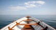 © sadia - Ocean Voyage Perspective: Front view of wooden rowing boat on calm blue sea, horizon and clouds, summer vacation, travel and freedom adventure concept