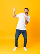 © luismolinero - Full-length shot of man with beard over isolated yellow background nervous and scared