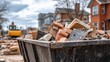 © dmmarychev - Metal dumpster filled with construction debris and brick rubble at demolition site