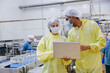 © Quality Stock Arts - Food hygiene inspector team work examination food production process in line at cannery food factory